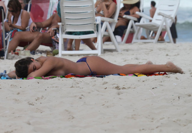 Após desamarrar o biquíni, Laisa relaxa na areia (Foto: Dilson Silva/AgNews)